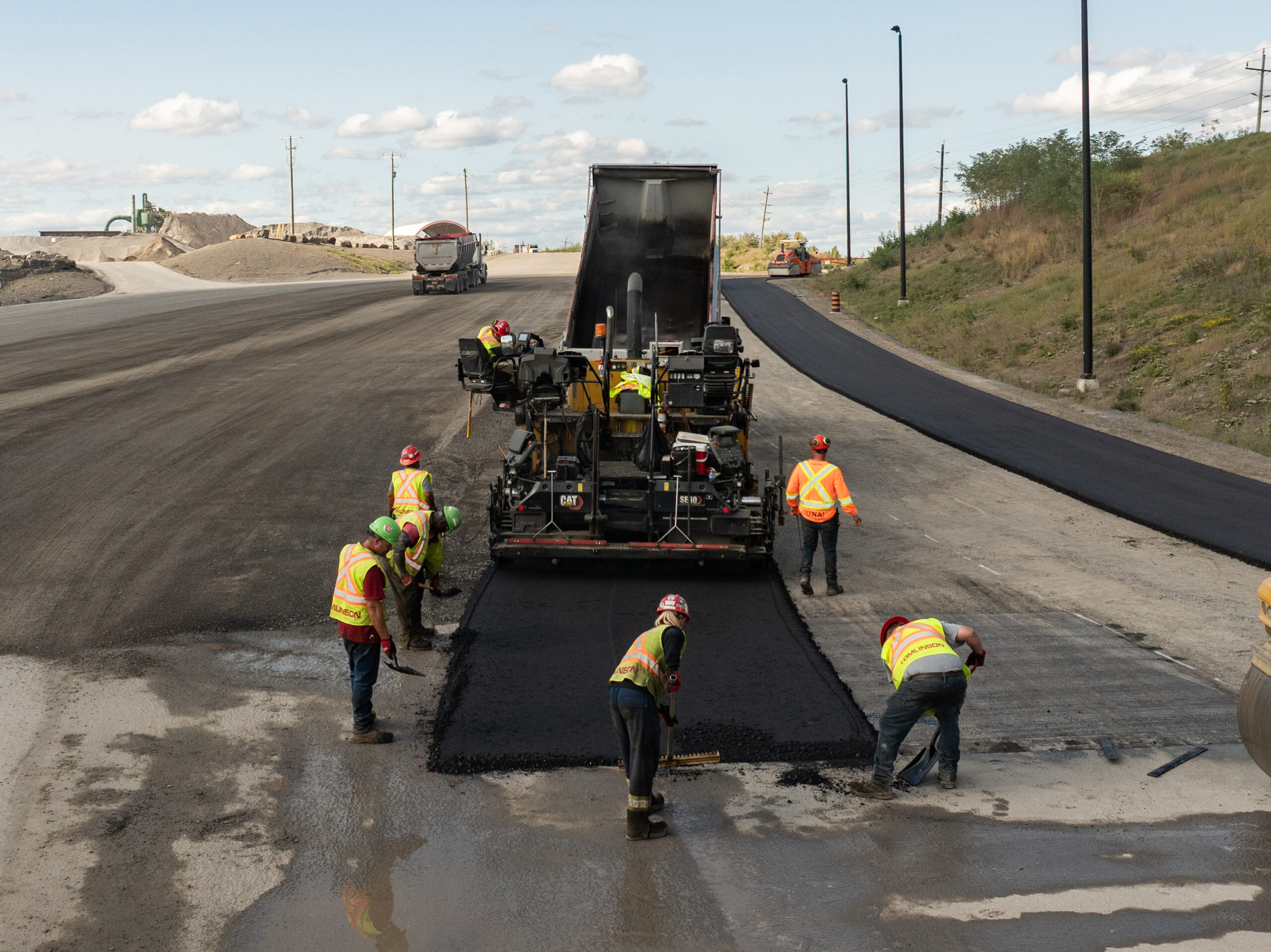 Harvest Green's biomass pyrolysis system and crew laying asphalt.